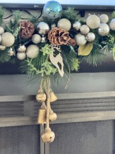 Christmas mantel with layered garland and warm white lights in Fairfield CT home