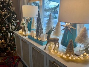 Cozy winter tablescape with greenery, candles, and mixed metallics