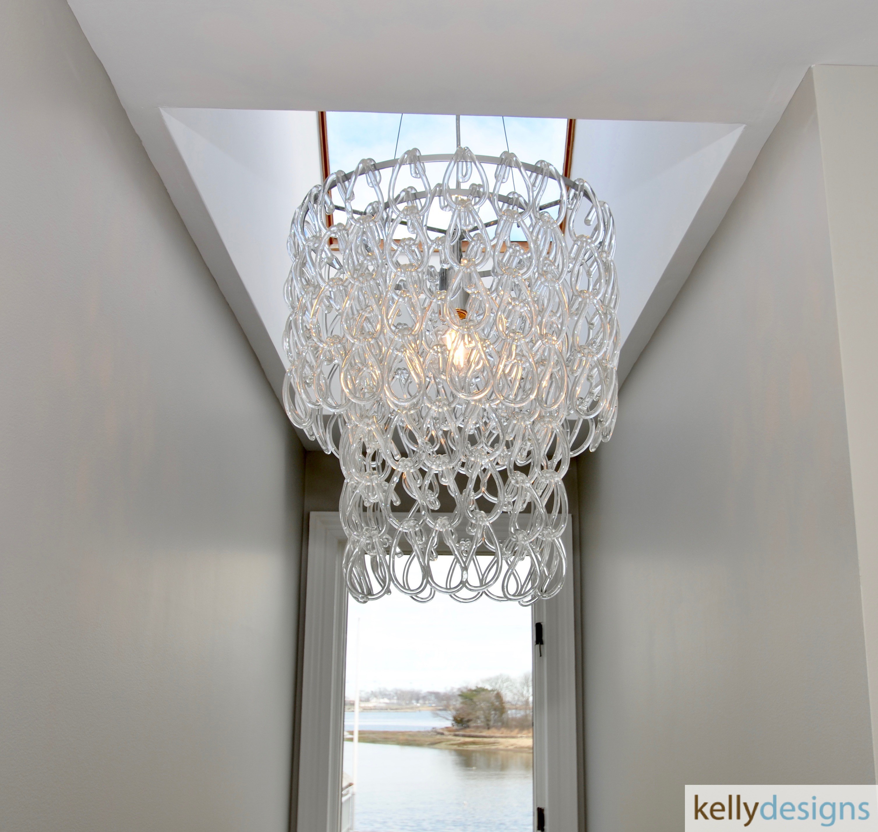 This stairway originally had a spotlight as the light fixture...this pretty glass loop chandelier adds to the pretty vista created out the window!