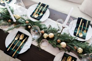 Classic Evergreen Garland Table Setting With Gold Accents and Plaid Napkins