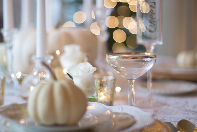 Soft White Holiday Table Setting With Pumpkins and Golden Details